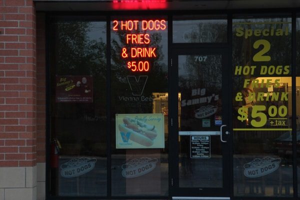 LED neon sign advertising “2 Hot Dogs Fries & Drink $5."