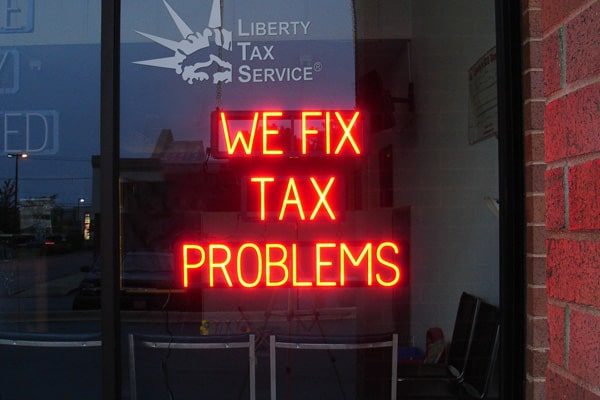 One of SpellBrite’s custom signs, created by Liberty Tax, that lets customers know “We Fix Tax Problems.”