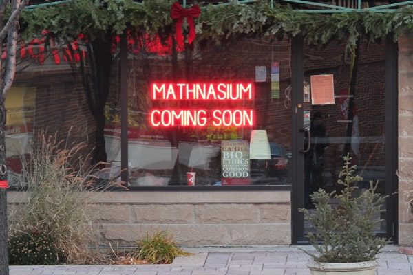 Here, LED light signs advertise “Mathnasium Coming Soon.”