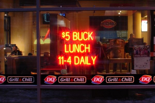 Custom restaurant sign that says “$5 Buck Lunch 11-4 Daily.”