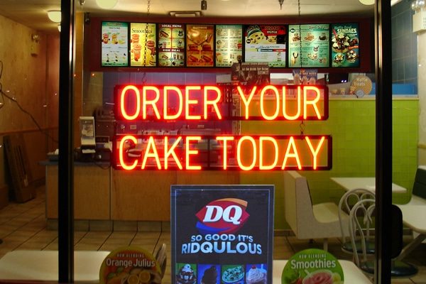 Custom LED neon sign telling customers to “Order Your Cake Today.”