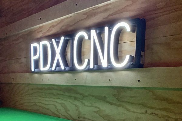 Custom LED sign with “PDX CNC.”