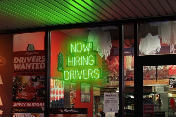 One of SpellBrite’s LED signs alerting passerby that the business is “Now Hiring Drivers.”