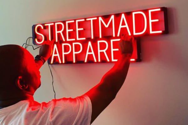 Neon LED sign featuring the words “Streetmade Apparel."