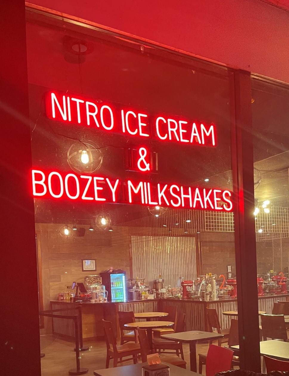 Image of the lighted business sign from Smokin’ Scoops, who used a SpellBrite LED sign to write out Nitro Ice Cream and Boozey Milkshakes